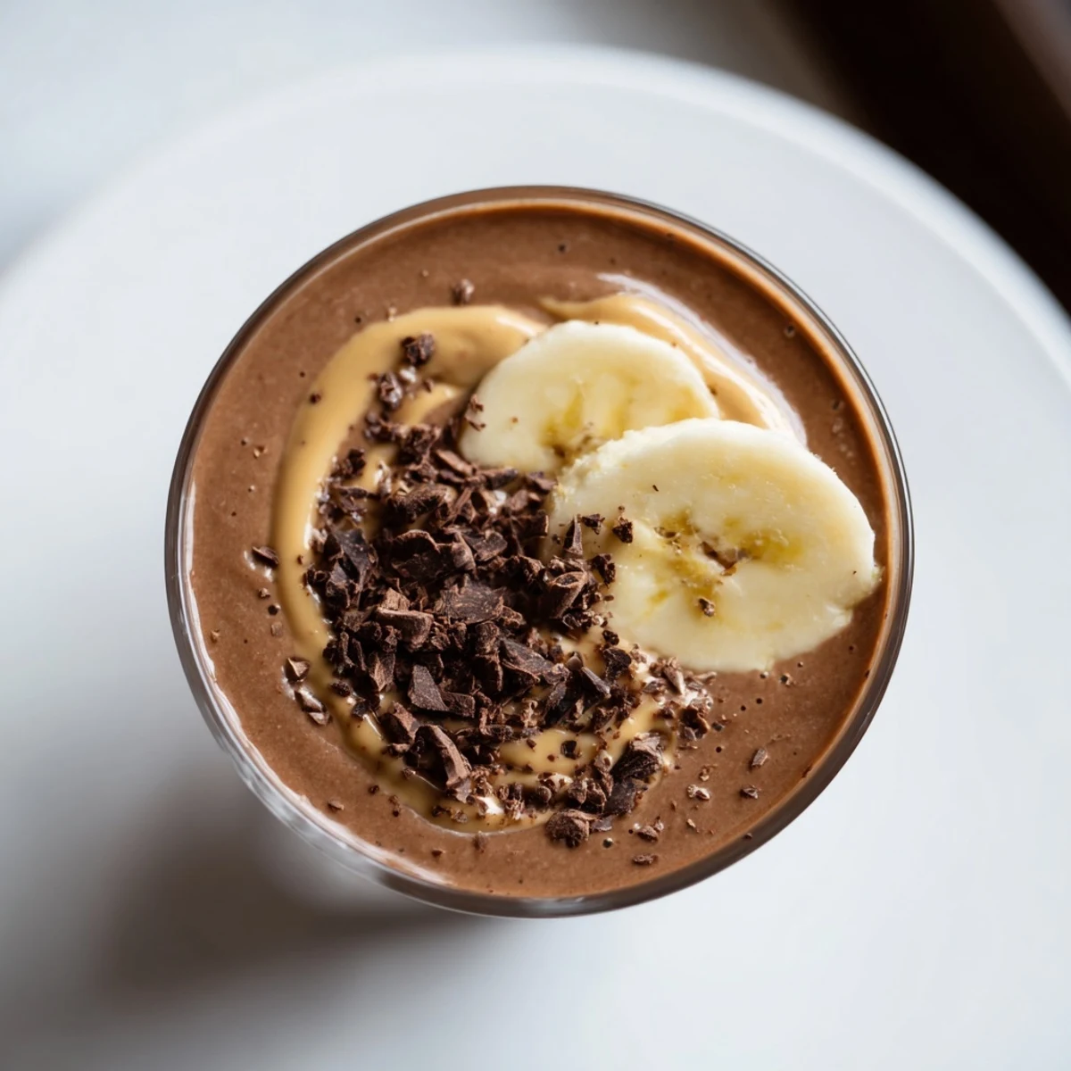 Two frosted glasses of Chocolate Peanut Butter Smoothie with Banana, blending cocoa and peanut butter for a satisfying breakfast or snack.