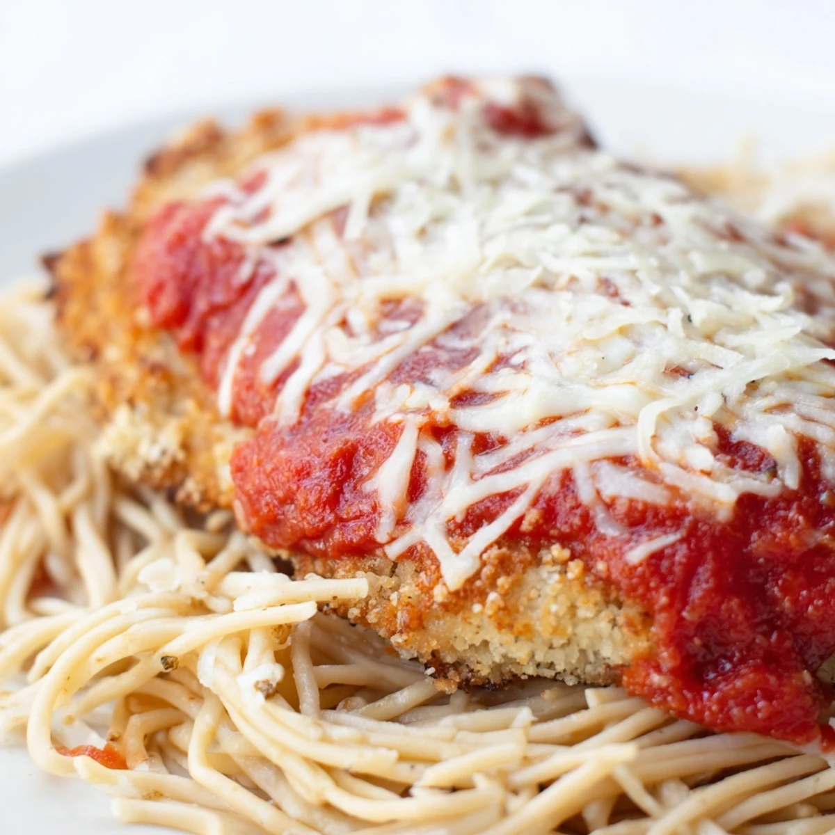 Golden, crispy Chicken Parmesan over spaghetti marinara, topped with bubbly melted mozzarella and fresh basil.