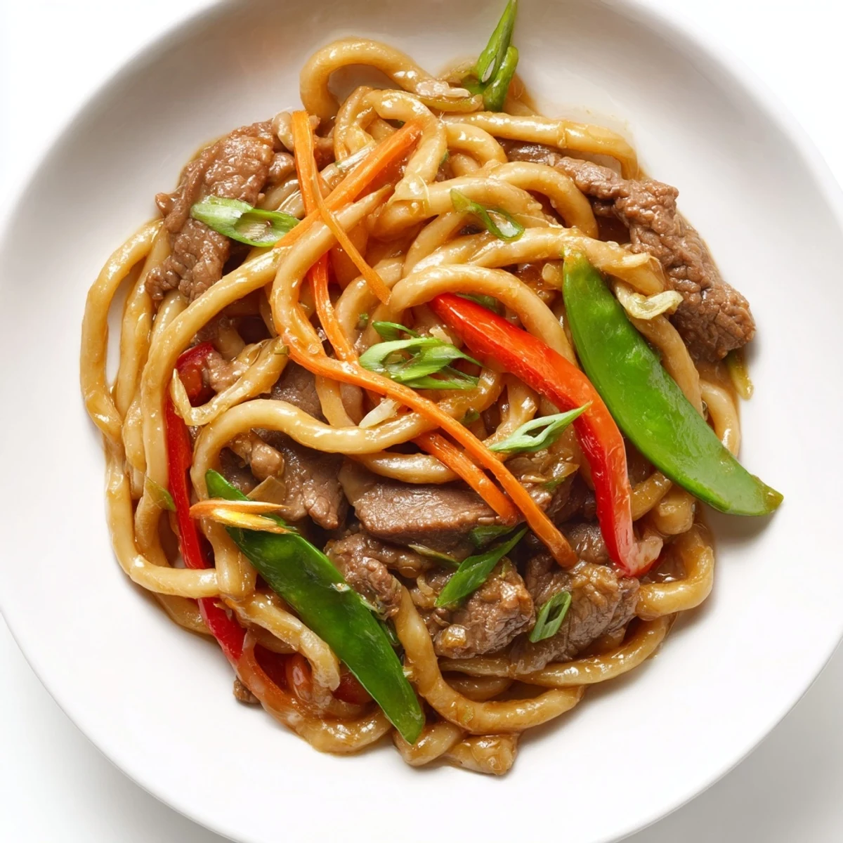 Crisp red bell peppers and onions tossed with chewy udon noodles in a glossy, spicy sauce.