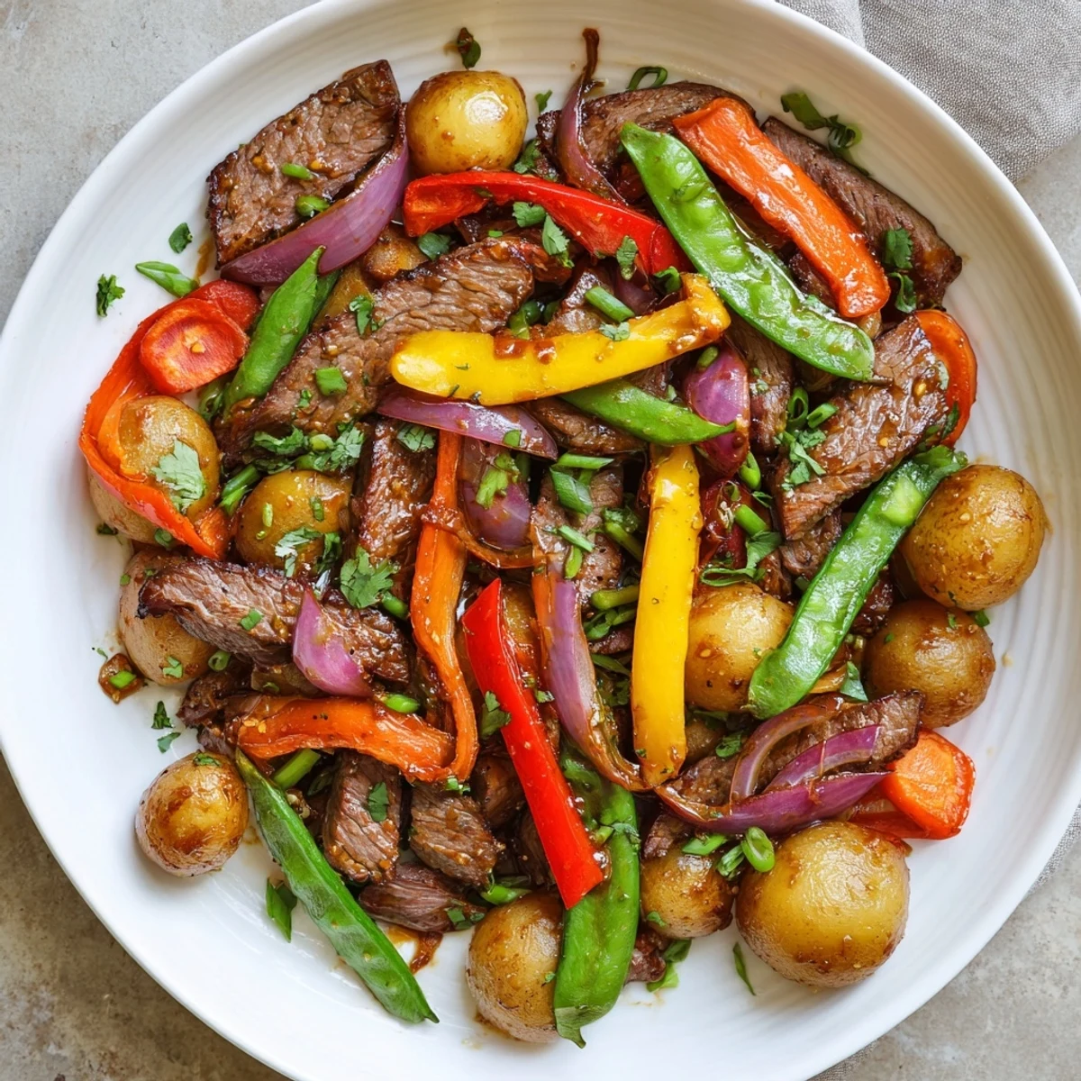 A sizzling Blackstone Cowboy Stir Fry Dinner with seared beef and vibrant bell peppers on the griddle.