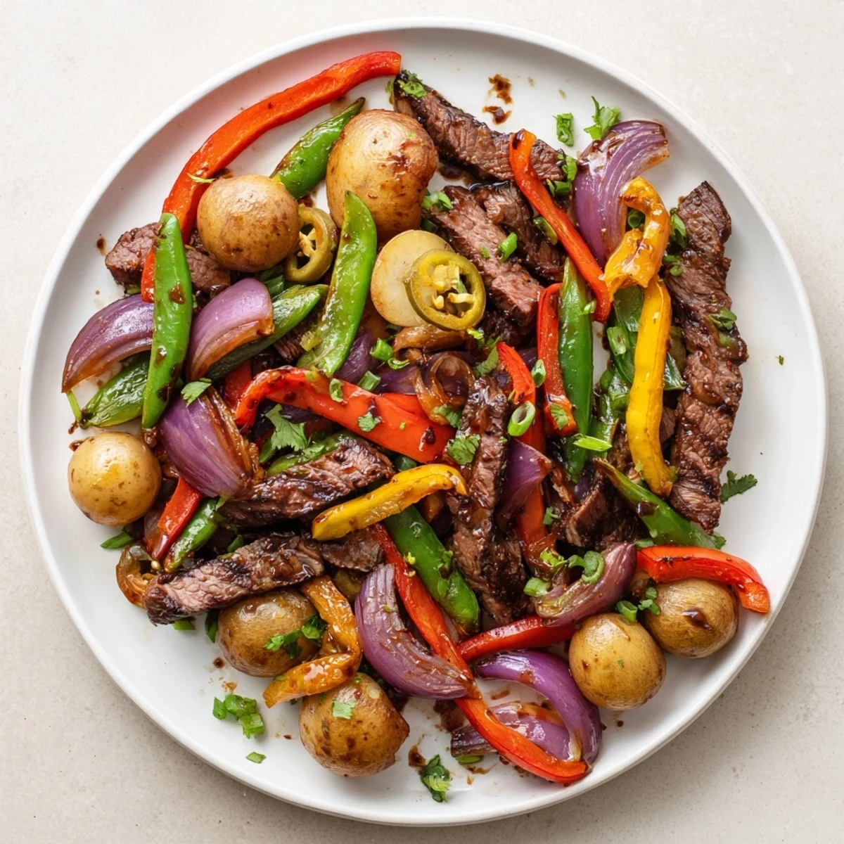 Cowboy-inspired stir fry on a Blackstone griddle, loaded with spicy jalapeños and golden potatoes for dinner.