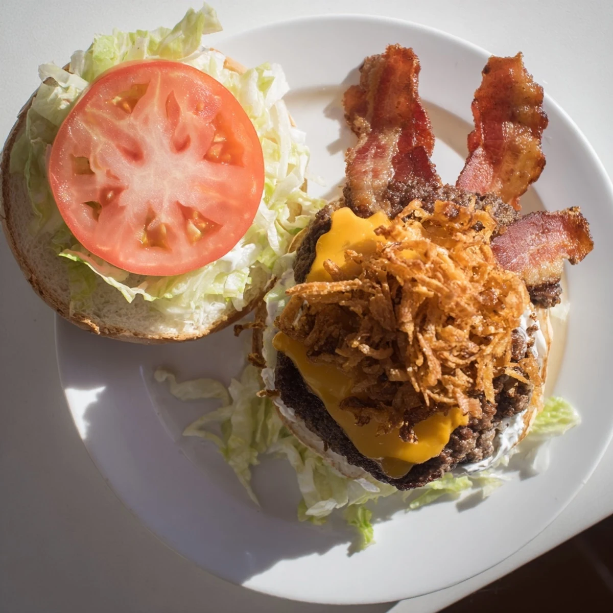 Close-up of Crack Burgers featuring crispy bacon, melted cheddar, ranch sauce, and fresh toppings on a burger bun.