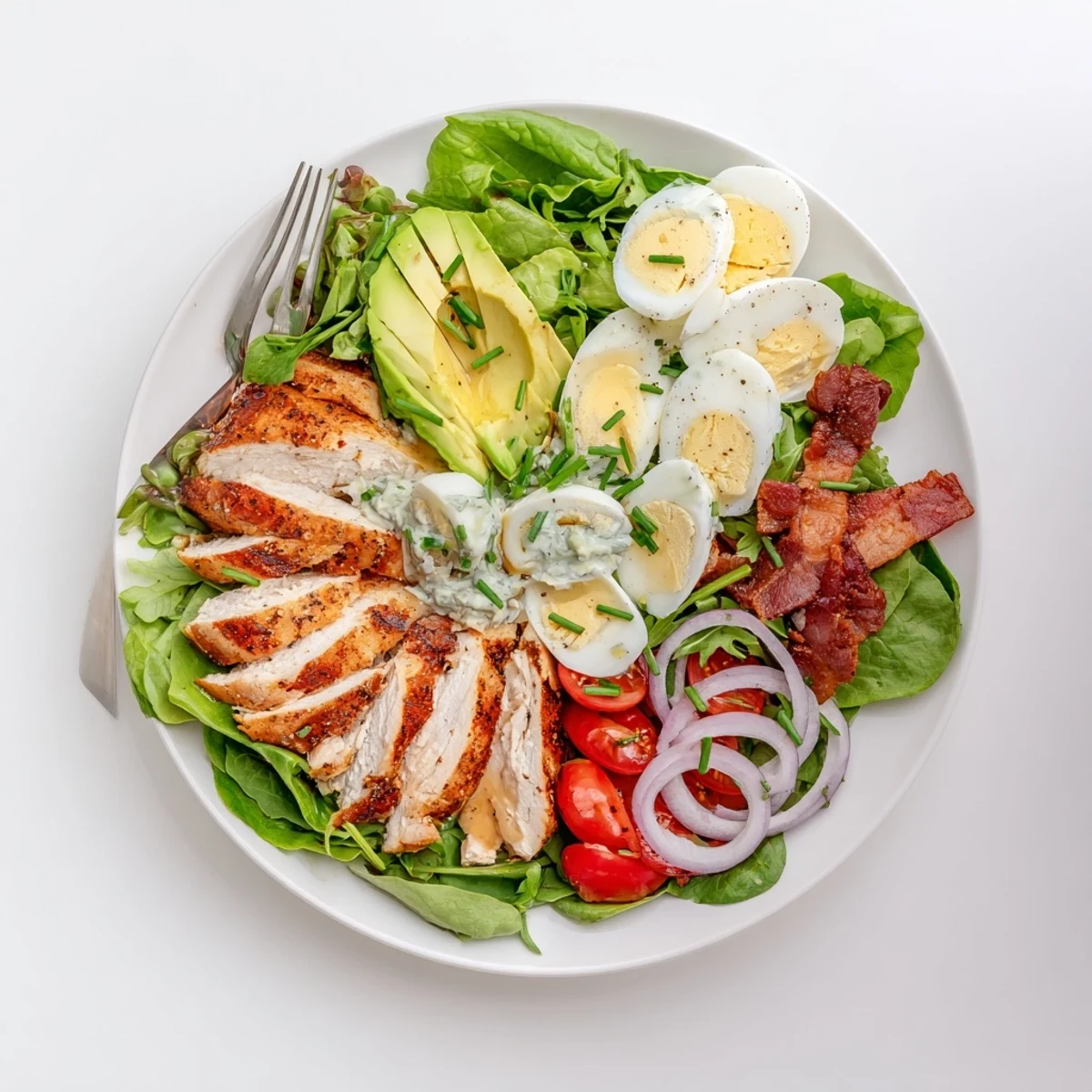 The Paleo Grilled Chicken Cobb Salad shows juicy grilled chicken, crispy bacon, and a honey Dijon dressing drizzled over fresh greens.