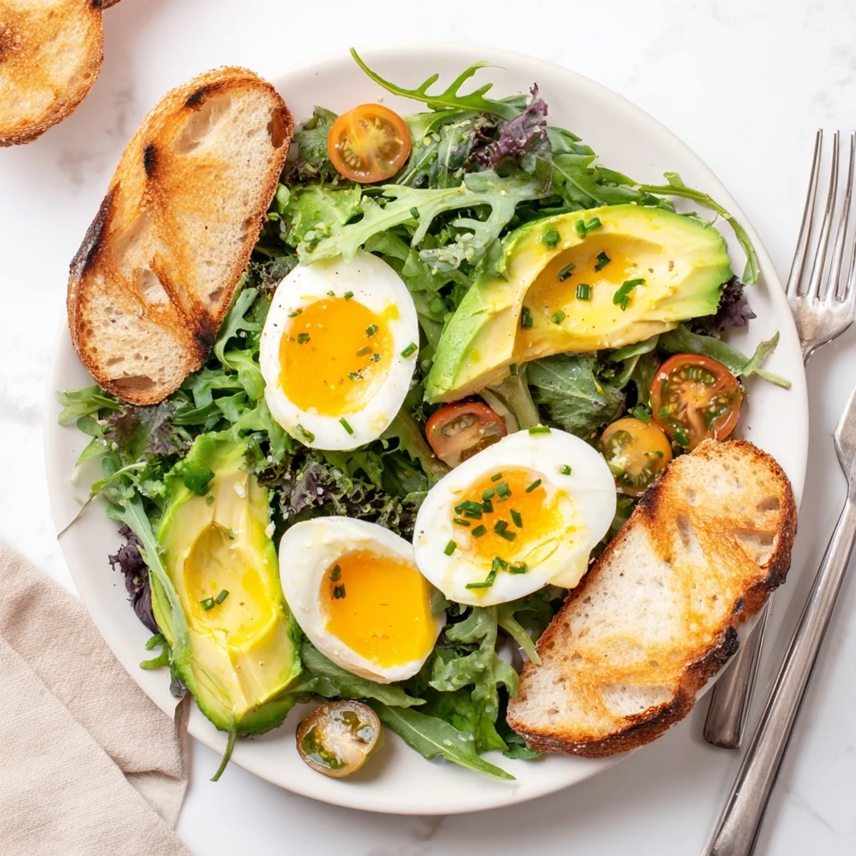 A nourishing breakfast spread featuring perfectly soft-boiled eggs, toasted artisan bread, and a fresh salad of mixed greens and cherry tomatoes.