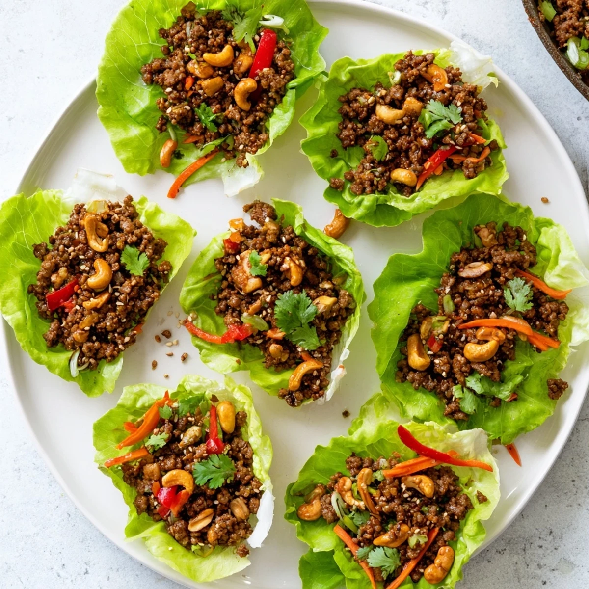 Savory beef and cashew lettuce cups filled with tender minced meat, crunchy cashews, and colorful diced vegetables in crisp butter lettuce leaves