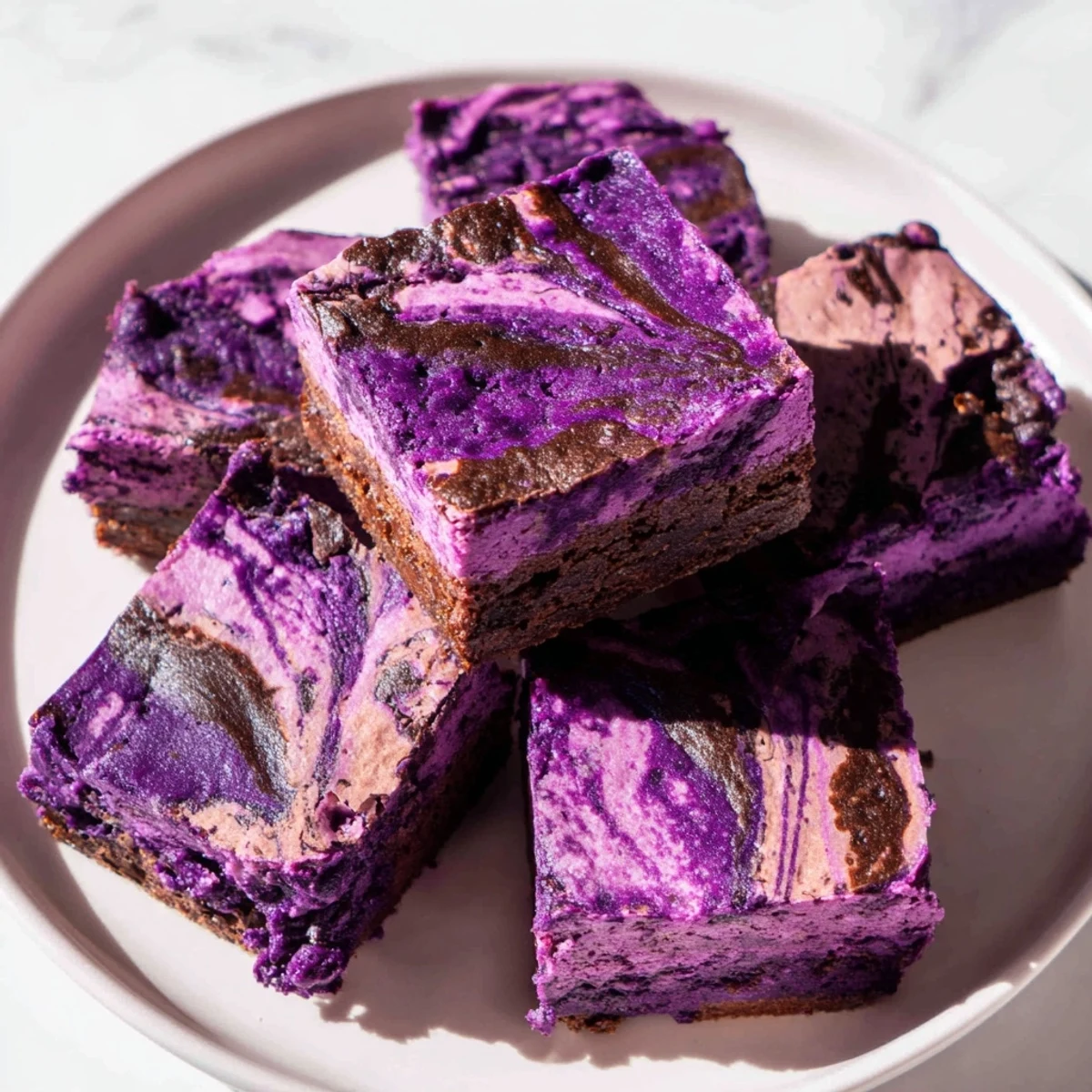 Rich Filipino ube brownies featuring vibrant purple yam and chocolate marbled topping