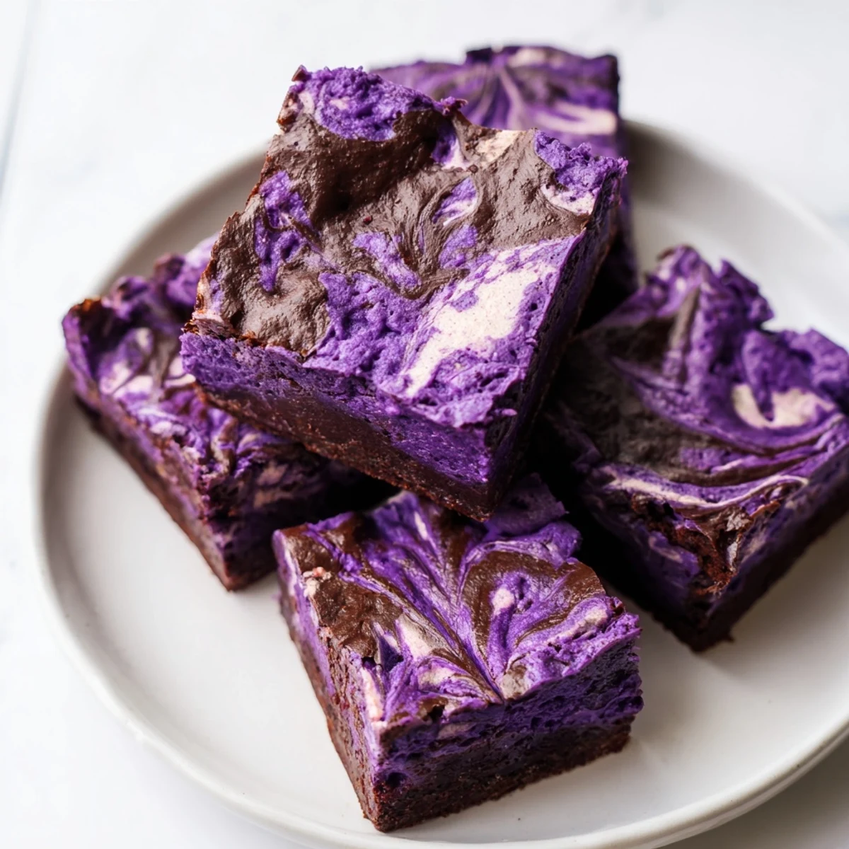 Homemade ube brownies cut into squares showing soft purple crumb and chocolate swirls