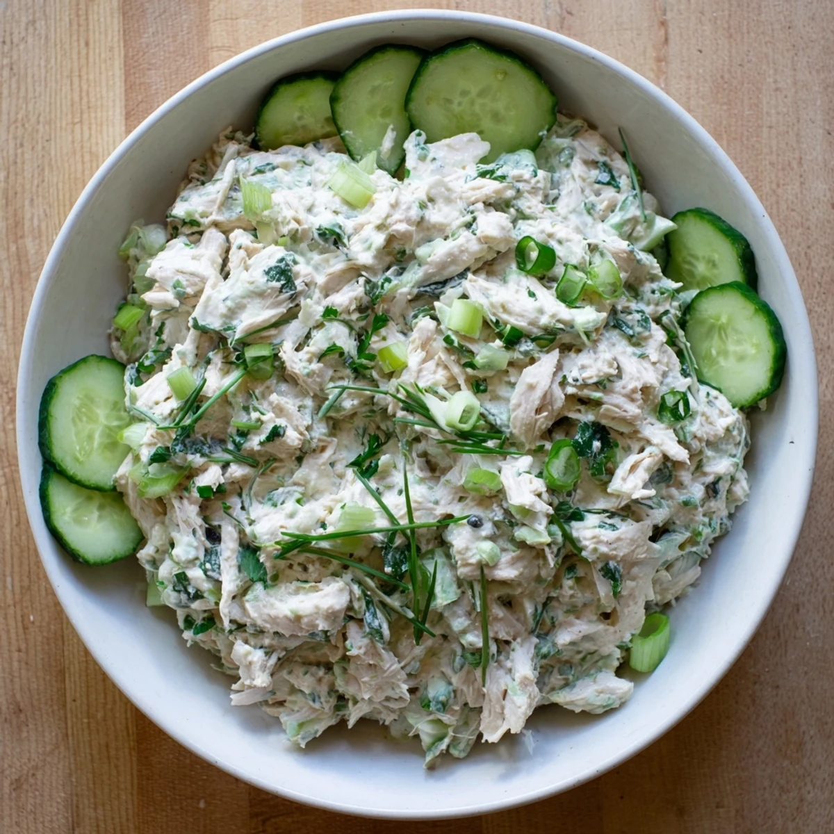 Green goddess chicken salad dip featuring herbaceous creamy dressing and garnished with radish slices and fresh chives