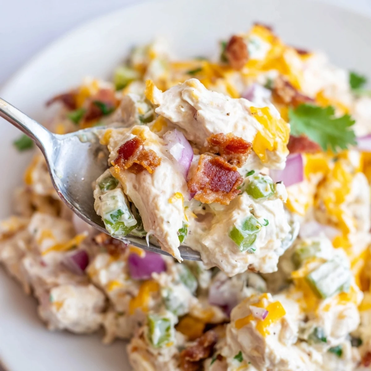 Low-carb jalapeno popper keto chicken salad featuring tender shredded chicken, sharp cheddar cheese, and smoky bacon pieces