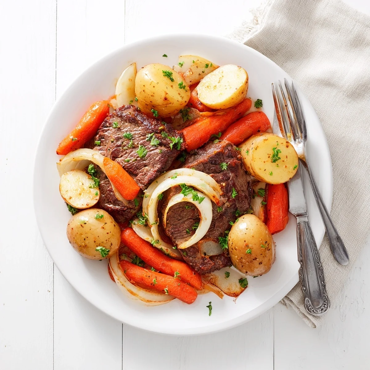 Fall-apart beef steaks nestled alongside buttery baby potatoes in this easy slow cooker steak and potatoes dinner