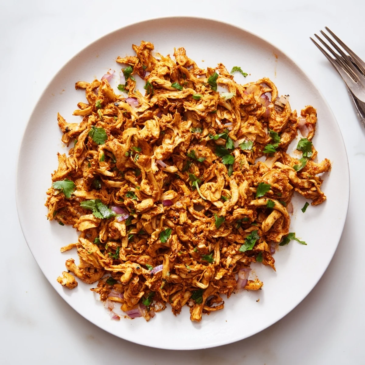 Crispy vegan carnitas featuring shredded oyster mushrooms seasoned with Mexican spices and lime