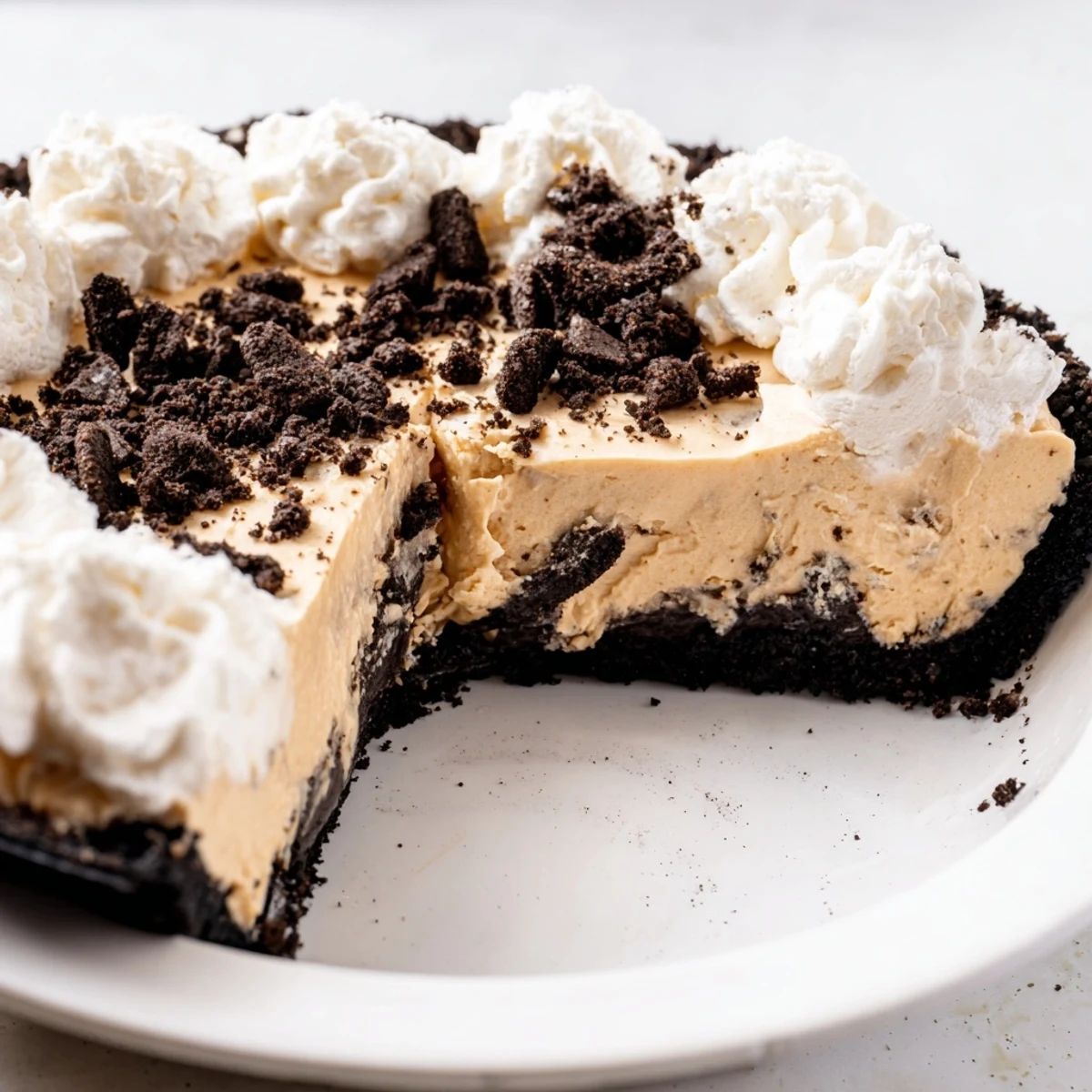Rich peanut butter Oreo pie with a thick chocolatey crust ready to serve at gatherings