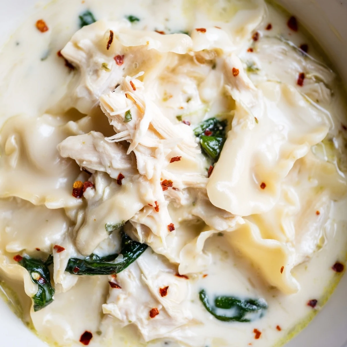 Creamy quick white lasagna soup with tender broken noodles, shredded chicken, and wilted spinach