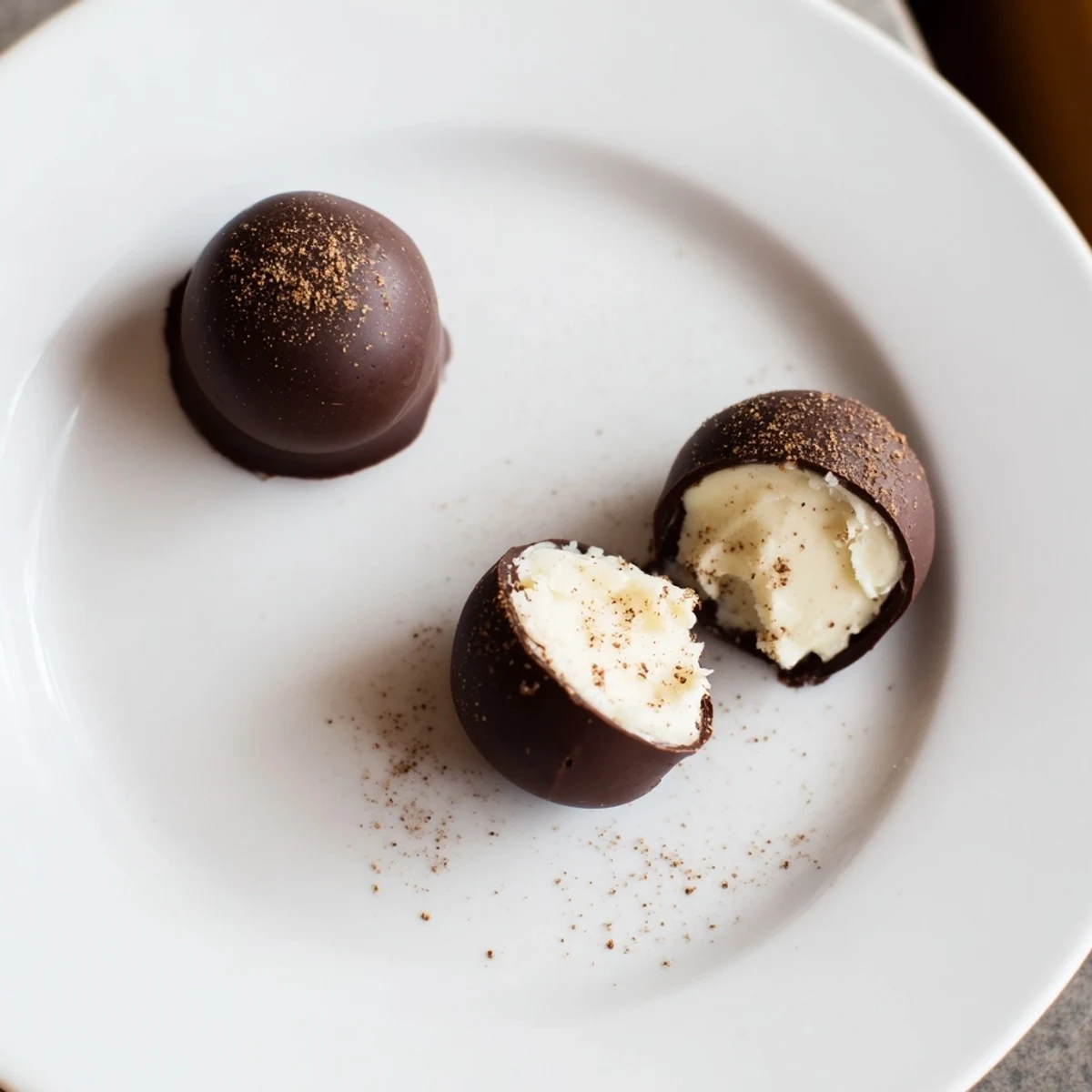 A plate of Dark Chocolate Eggnog Truffles, creamy centers and warm spice