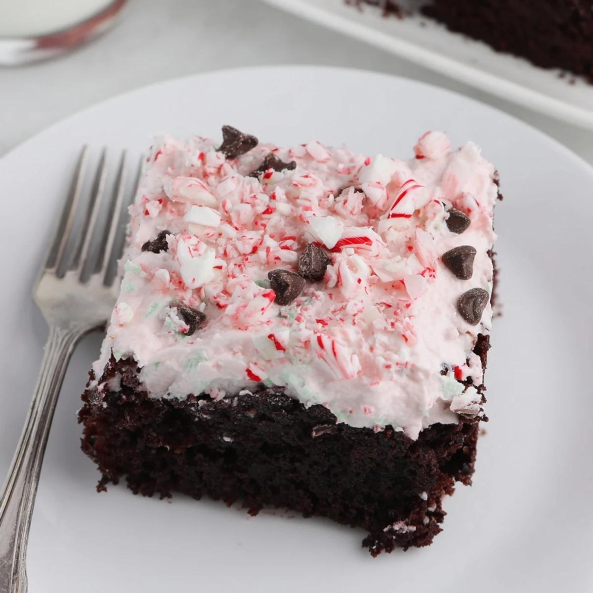 Chilled Peppermint Poke Cake showing minty vanilla pudding seeping into chocolate