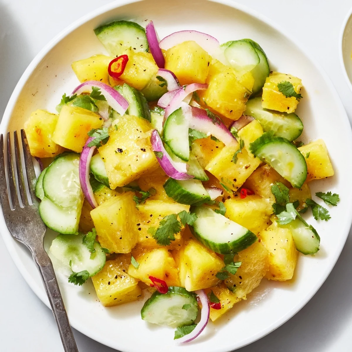 Summer Pineapple Cucumber Salad served beside grilled chicken, zesty and refreshing.
