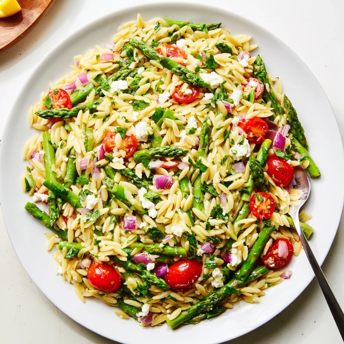 Fork-ready Asparagus Orzo Salad With Lemon Vinaigrette, chilled, tangy, sprinkled with feta