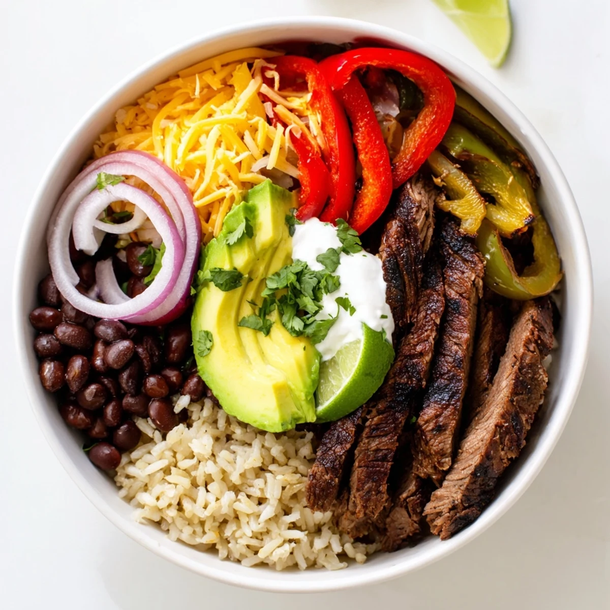Steak Fajita Power Bowls with sizzling marinated steak, charred peppers and lime.