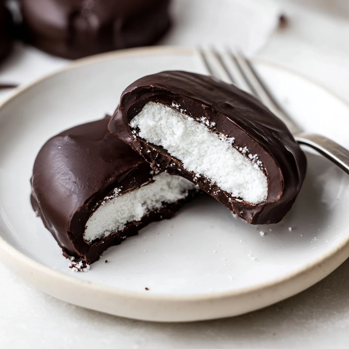 Peppermint Patties: glossy dark chocolate shells encasing cool mint filling, on parchment.