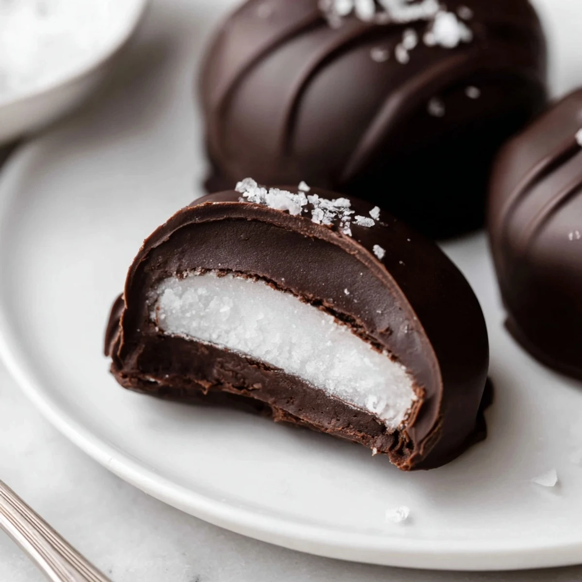 Homemade Peppermint Patties chilled on baking sheet, dusted with crushed candy.