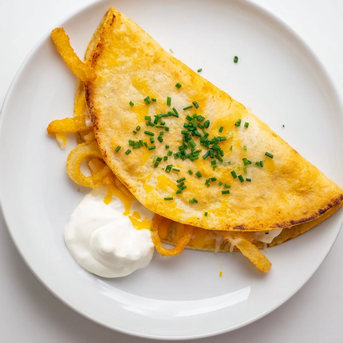 Tex-Mex quesadillas stuffed with fried onion rings and gooey cheese served with sour cream