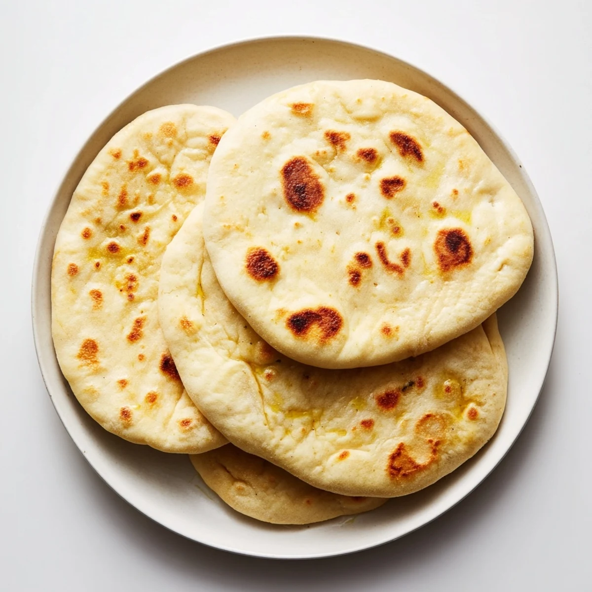 Golden Turkish Bazlama flatbread with pillowy soft texture and charred spots perfect for dipping