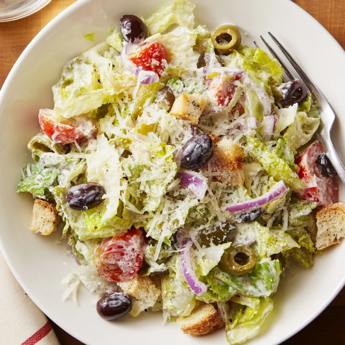 Crisp homemade Olive Garden Salad topped with croutons and creamy Parmesan dressing