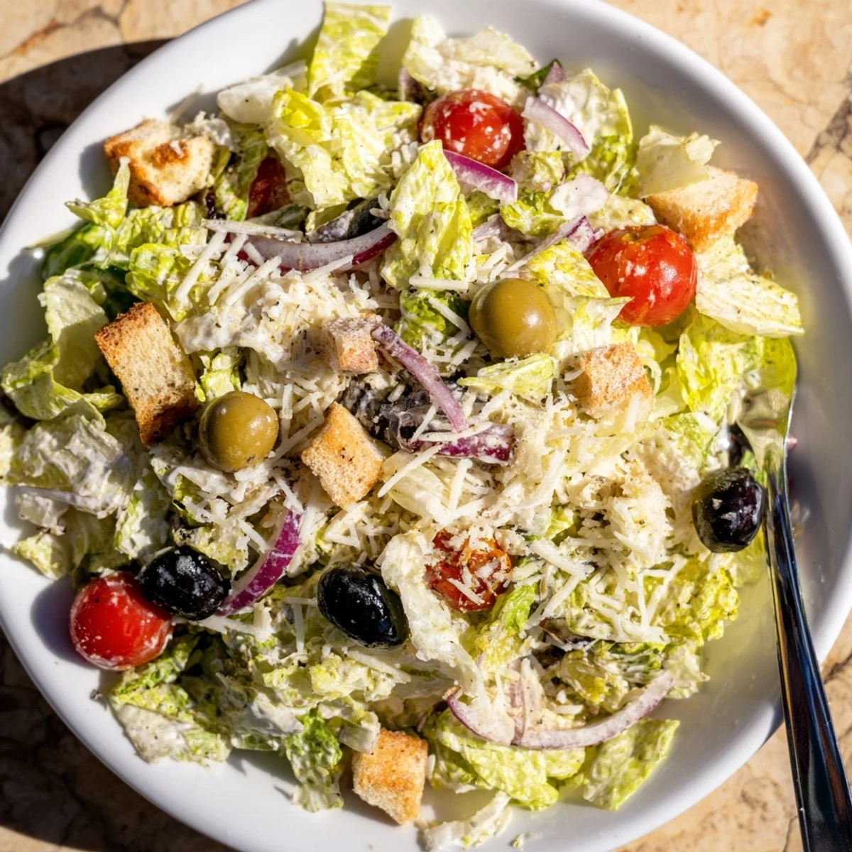 Colorful Olive Garden Salad in a bowl with tomatoes olives and pepperoncini