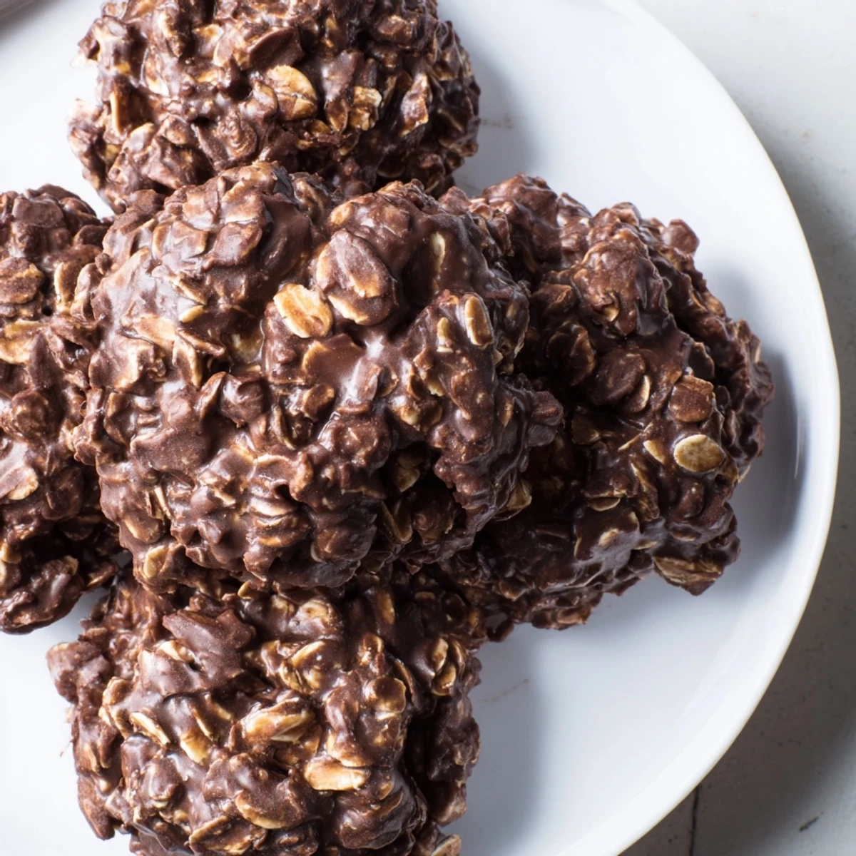 Fudgy chocolate oatmeal no bake cookies cooling on a sheet ready for snacking